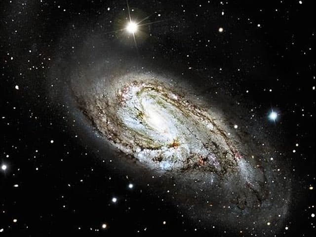 APOD: Unusual Spiral Galaxy M66 - April 7, 2004