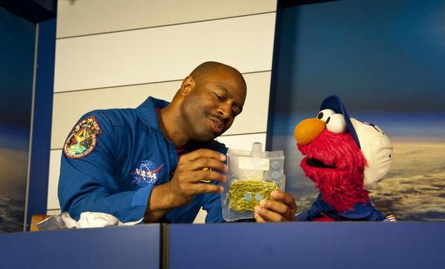 NASA image: Former Astronaut Leland Melvin speaks with Elmo