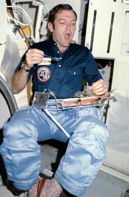 NASA image: Candid views of STS-41C crew preparing food on middeck 