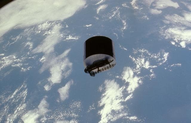 NASA image: View of the Syncom IV satellite in orbit over the earth
