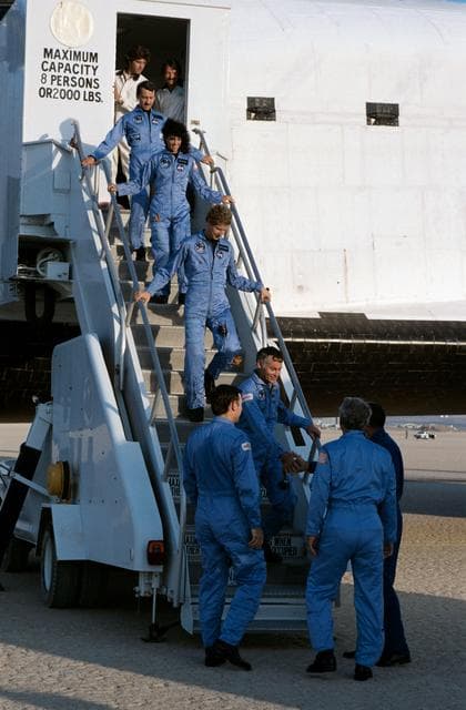 NASA image: Crew of STS 41-D mission exit orbiter after landing