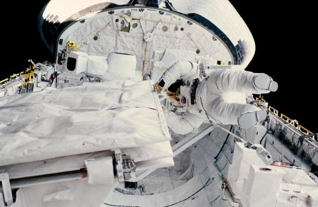 NASA image: Astronaut Kathryn Sullivan checks SIR-B antenna during EVA
