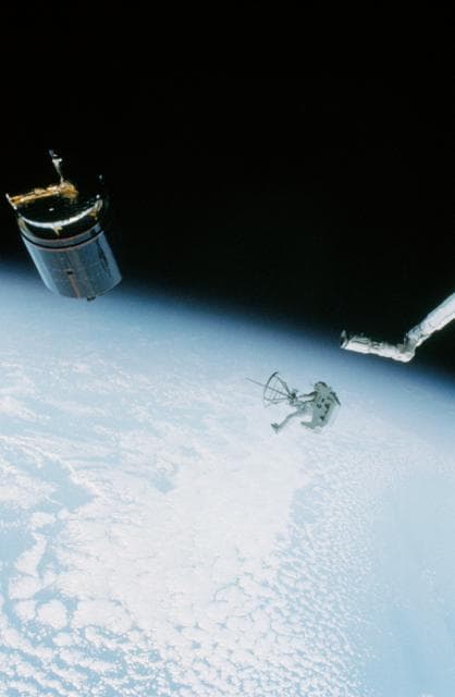 NASA image: Astronat Dale Gardner using MMU to travel to Westar VI satellite