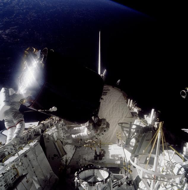 NASA image: Astronauts Gardner and Allen during loading of Palapa B-2 in payload bay