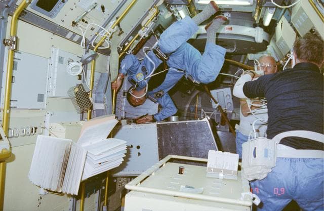 NASA image: Payload Specialist Taylor Wang performs repairs on Drop Dynamics Module