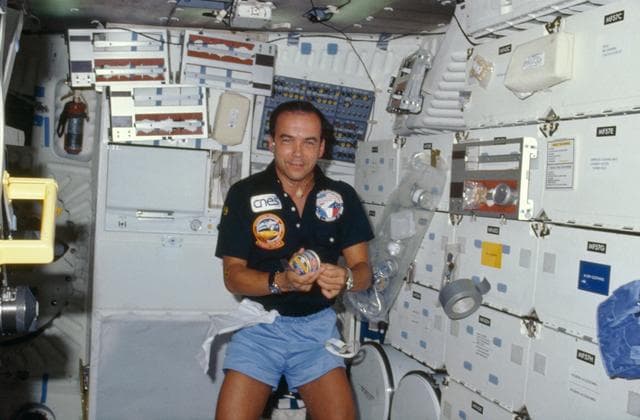NASA image: French payload specialist Patrick Baudry prepares a meal
