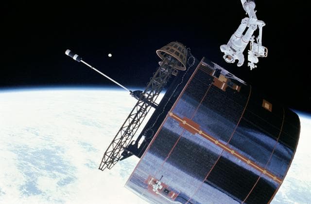 NASA image: Astronaut James van Hoften working with Syncom IV-3 satellite