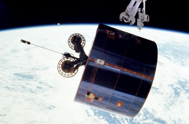 NASA image: Astronaut James van Hoften working with Syncom IV-3 satellite