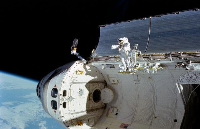 NASA image: Astronaut William Fisher anchored to foot restraint on Discovery