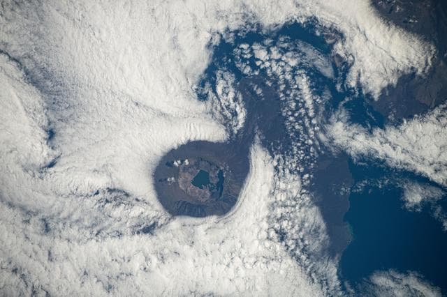 NASA image: Clouds swirl around a caldera on Fernandina Island