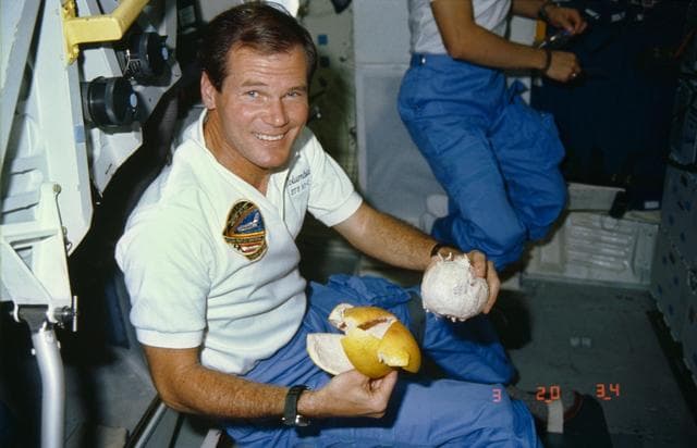 NASA image: Representative Bill Nelson prepares to eat a peeled grapefruit