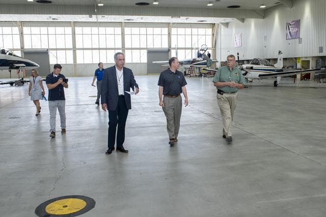 NASA image: NASA Administrator Bridenstine and Armstrong Center Director McBride discuss the capabilities and use of aircraft for flight research inside one of the aircraft hangars at the center.