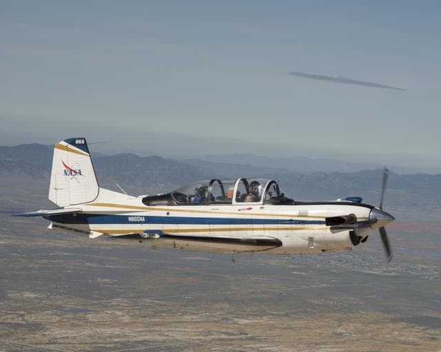 NASA image: NASA Aircraft heads to Southern California’s Poppy Reserve in the foreground. Rainy Season made the Antelope Valley colorful with poppies and wildflowers.