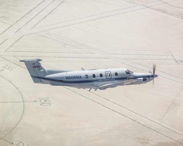 NASA image: NASA’s Pilatus PC-12 flies over the world’s largest compass rose at NASA’s Armstrong Flight Research Center in Edwards, California on Sept. 18, 2024
