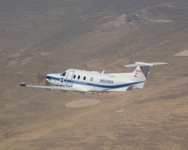 NASA image: The Mojave Desert serves as a stark background for NASA’s Pilatus PC-12 flying near Armstrong Flight Research Center in Edwards, California on Sept. 18, 2024.
