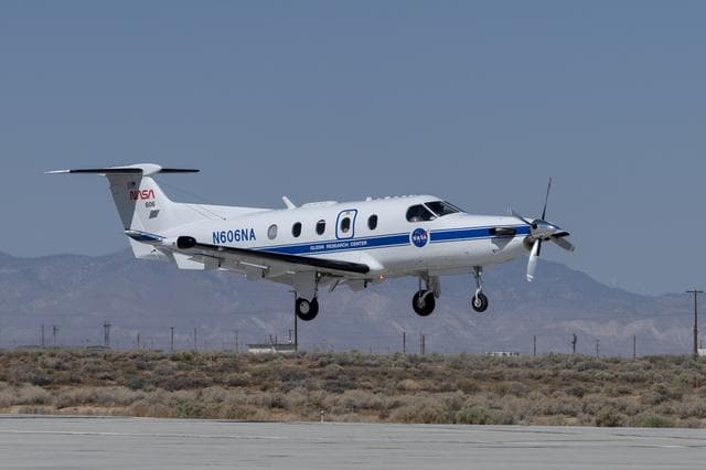 NASA image: NASA Pilatus PC-12 performs touch-and-go maneuvers over the runway at NASA’s Armstrong Flight Research Center in Edwards, California to gather data on low-altitude Automatic Dependent Surveillance-Broadcast signals on Sept. 23, 2024.