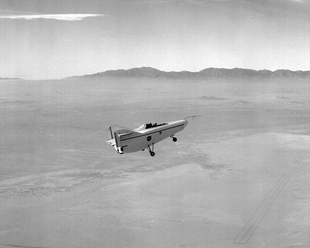 NASA image: M2-F1 in flight over lakebed on tow line