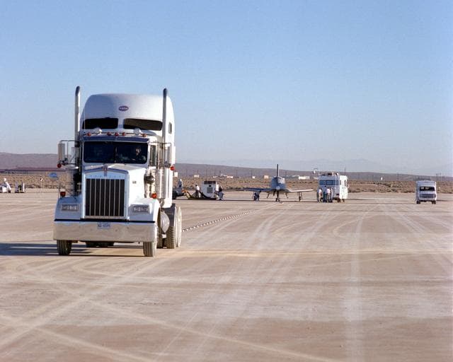 NASA image: X-34 and HSTV tow vehicle on lakebed prior to tow test