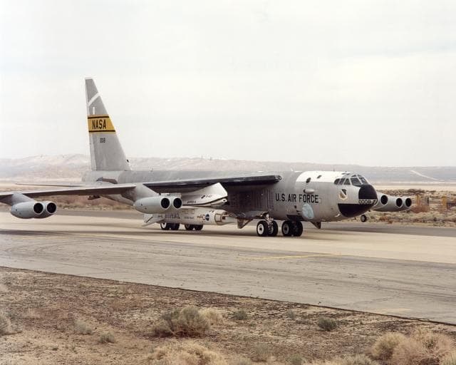 NASA image: NASA's NB-52B carrier aircraft rolls down a taxiway with the X-43A hypersonic research aircraft and its modified Pegasus® booster rocket slung from a pylon under its right wing