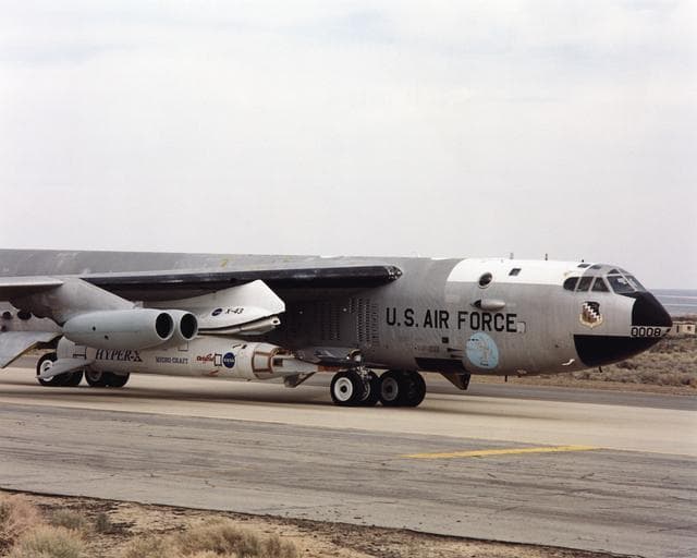 NASA image: NASA's NB-52B carrier aircraft rolls down a taxiway with the X-43A hypersonic research aircraft and its modified Pegasus® booster rocket attached to a pylon under its right wing.
