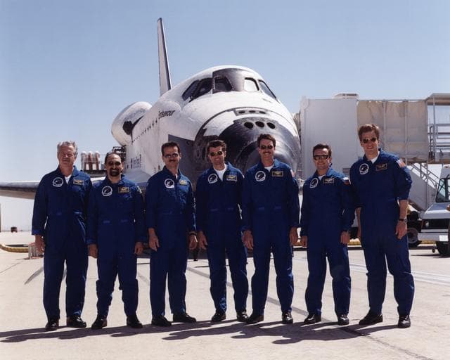 NASA image: The crew of Space Shuttle mission STS-100 gathered in front of the shuttle Endeavour following landing at Edwards Air Force Base, California, 9:11 am, May 1, 2001