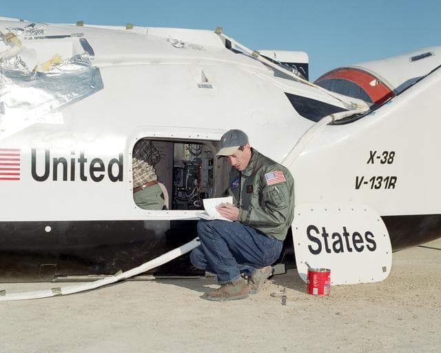 NASA image: NASA engineer Wayne Peterson from the Johnson Space Center reviews postflight checklists following a spectacular flight of the X-38 Vehicle 131R