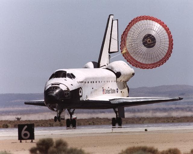 NASA image: The Space Shuttle Endeavour's drag chute deploys to slow the orbiter as it rolls out on Runway 22 at Edwards Air Force Base at the conclusion of its 14-day STS-111 mission to the International Space Station
