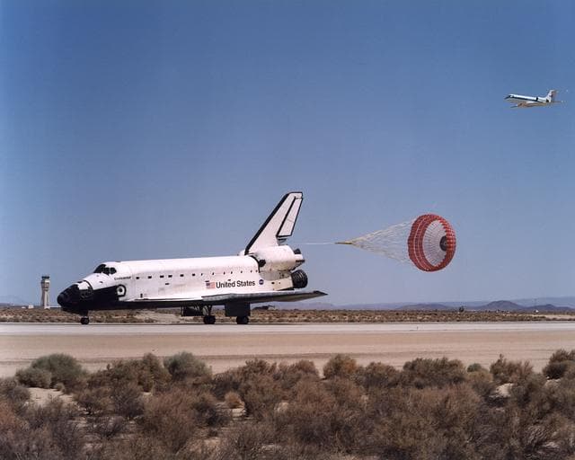 NASA image: The Space Shuttle Endeavour's drag chute deploys to slow the orbiter as it rolls out on Runway 22 at Edwards Air Force Base at the conclusion of its 14-day STS-111 mission to the International Space Station
