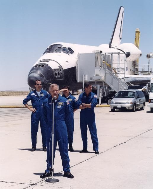 NASA image: STS-111 commander Ken Cockrell greets dignitaries and recovery technicians on the runway at Edwards Air Force Base following the landing of the space shuttle Endeavour on June 19, 2002. Behind Cockrell are (from left) mission specialists Philippe Perrin a