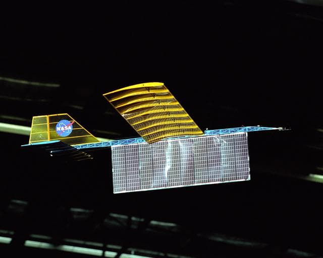 NASA image: An experimental radio-controlled model aircraft is seen here in flight, powered only by light energy beamed to it by a spotlight.