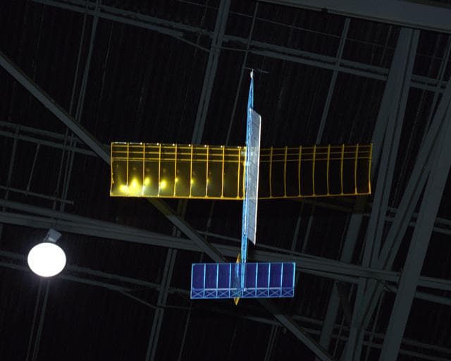 NASA image: An experimental radio-controlled model aircraft is seen here in flight, powered only by light energy beamed to it by a spotlight.
