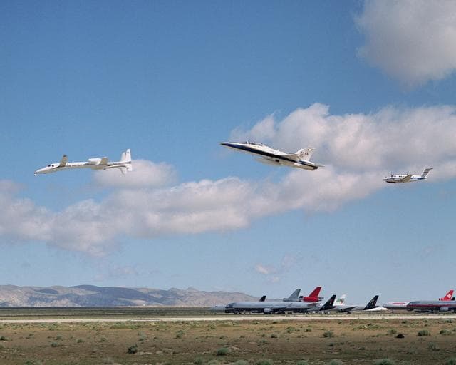 NASA image: Scaled Composites' Proteus aircraft with an F/A-18 Hornet and a Beechcraft KingAir from NASA's Dryden Flight Research Center during a low-level flyby at Mojave Airport in Southern California.