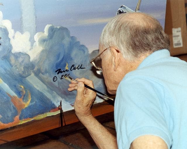 NASA image: Bob McCall signs the Centennial of Flight mural in the artist's studio in Paradise Valley, Arizona.