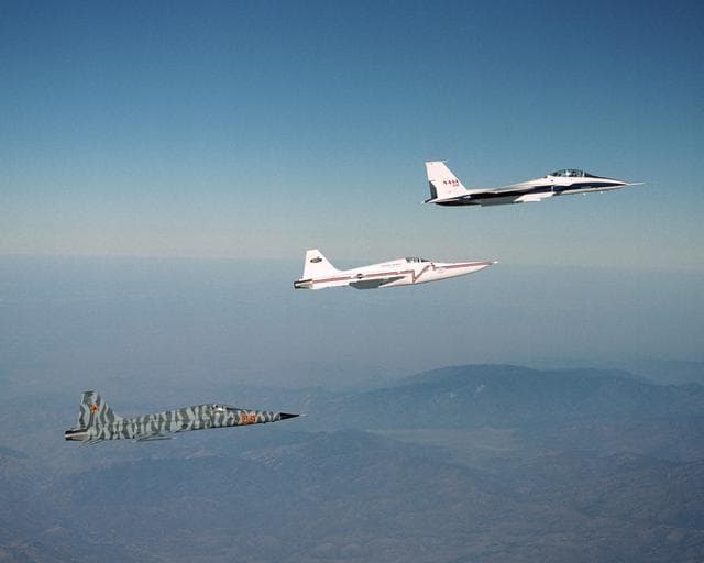 NASA image: Northrop Grumman Corp.'s modified F-5E Shaped Sonic Boom Demonstration (SSBD) aircraft flies off the wing of NASA's F-15B Research testbed aircraft.