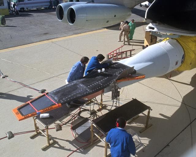 NASA image: The second X-43A hypersonic research vehicle, mounted under the right wing of the B-52B launch aircraft, viewed from the B-52 cockpit