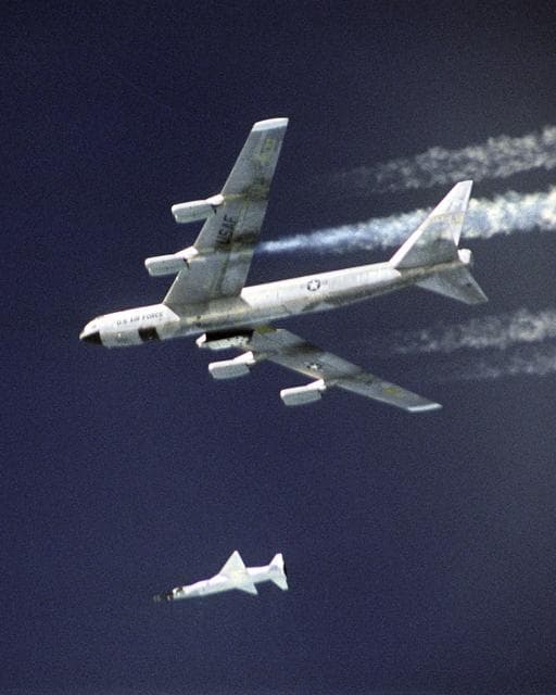 NASA image: A modified Pegasus rocket drops steadily away after release from NASA's B-52B, before accelerating the X-43A over the Pacific Ocean on March 27, 2004