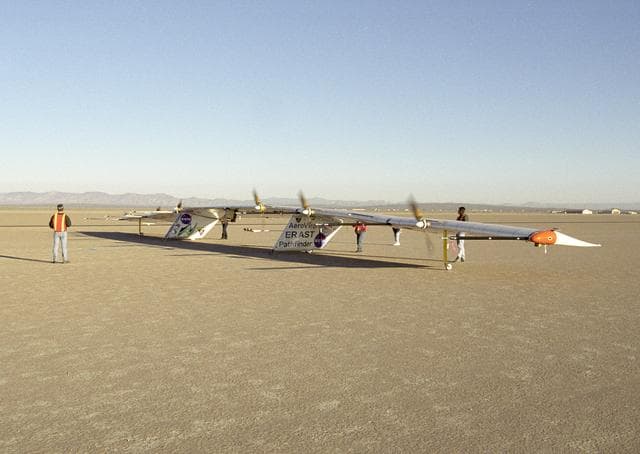 NASA image: AeroVironment ground crew check out the operation of the Pathfinder-Plus solar aircraft's electric motors during combined systems tests on Rogers Dry Lake.