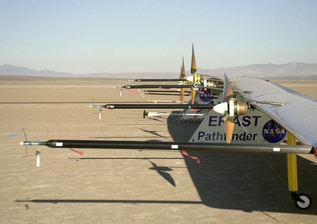 NASA image: Sensitive instruments on wing-mounted booms measure air turbulence and its effect on the stability of the Pathfinder-Plus solar-electric flying wing.