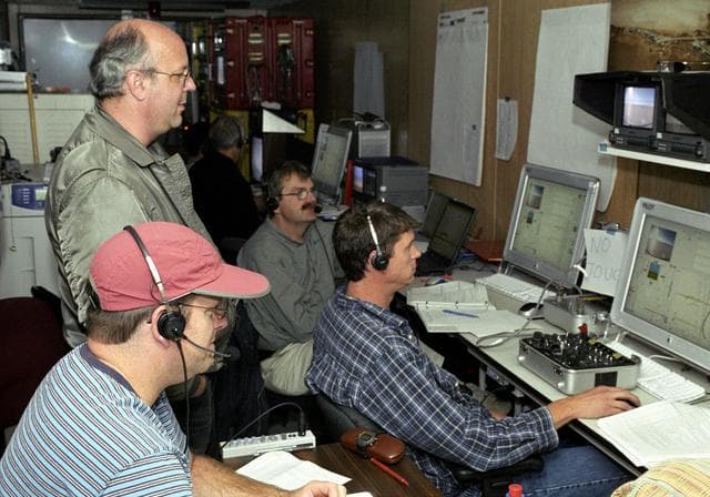 NASA image: AeroVironment's Jim Daley, Rik Meininger, Derek Lisoski and Wyatt Sadler (clockwise from bottom left) closely monitor systems testing of the Pathfinder-Plus.