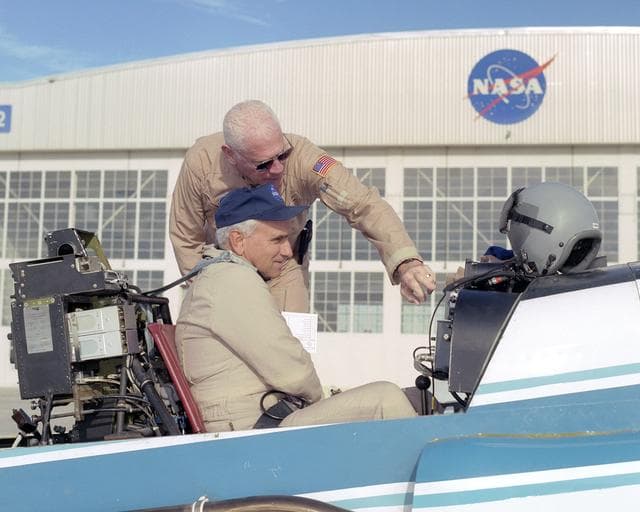 NASA pilot Ed Lewis (rear) briefs NASA test pilot Dick Ewers on the flight instruments of NASA's YO-3A acoustics research aircraft prior to a checkout flight.