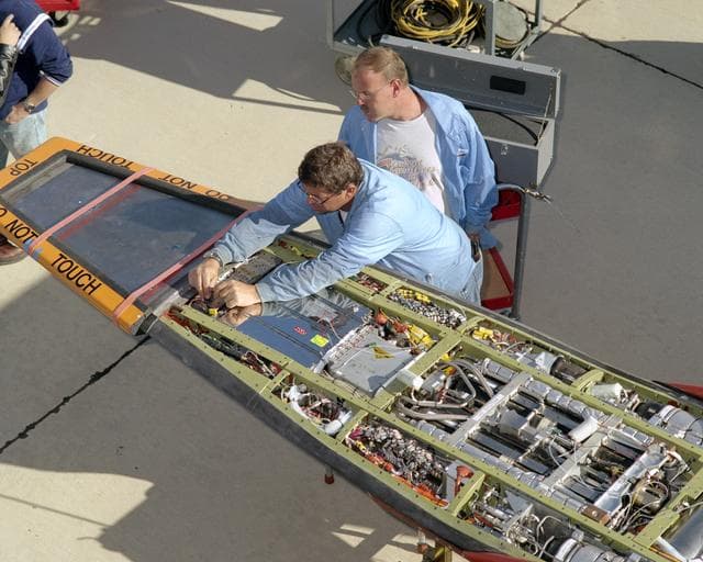 NASA image: NASA avionics technicians Randy Wagner and Terry Bishop make final adjustments on the scramjet-powered X-43A before its record Mach 9.6 flight