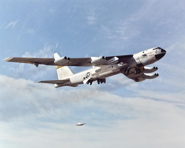 NASA image: With the X-43A and its booster rocket tucked under its right wing, NASA's venerable B-52B mothership climbs out after takeoff on its final research mission