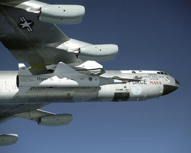 NASA image: NASA's B-52B launch aircraft cruises to a test range over the Pacific Ocean carrying the third X-43A vehicle attached to a Pegasus rocket on November 16, 2004