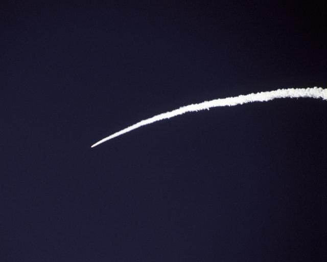 NASA image: The Pegasus rocket that powered NASA's X-43A scramjet to almost Mach 10 test conditions leaves a bright arc in the Pacific sky during the boost phase