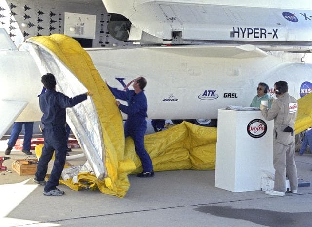 NASA image: Orbital Sciences Corp. technicians remove protective shrouds from the modified Pegasus booster before takeoff on the X-43A's Mach 9.6 record scramjet flight
