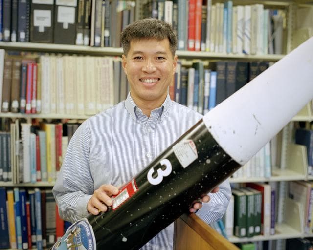 NASA image: Trong Bui, NASA Dryden's principal investigator for the aerospike rocket tests, with one of two rockets flown in the first tests.