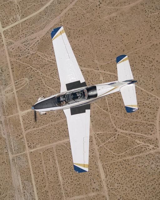NASA image: A Beech T-34C mission support aircraft flown by NASA Dryden Flight Research Center shows off its classic lines as it soars over the desert near Edwards AFB