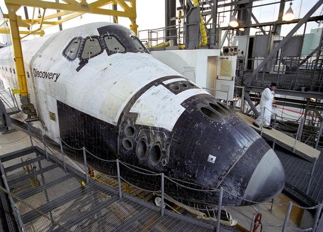 NASA image: A technician leaves the 'white room,' the access point for entering the Space Shuttle Discovery during post-flight processing at NASA DFRC in California