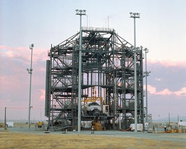 NASA image: The sun sets on the Space Shuttle Discovery during post-flight processing in the Mate-Demate Device (MDD), following its landing at NASA DFRC in California