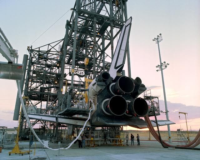 NASA image: The sun sets on the Space Shuttle Discovery during post-flight processing in the Mate-Demate Device (MDD), following its landing at NASA DFRC in California